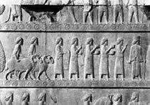 Apadana of Darius (ca. 520 BC)-Detail of the middle register of the left side of the eastern stairway, showing foreigners bringing tribute